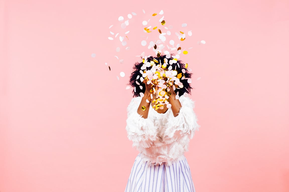 Celebration of happiness, young woman throwing confetti